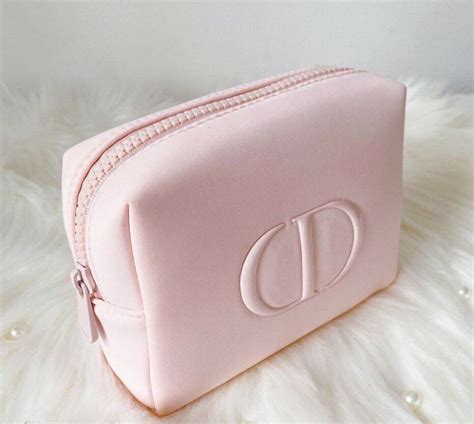 3 makeup products in a Dior pouch .